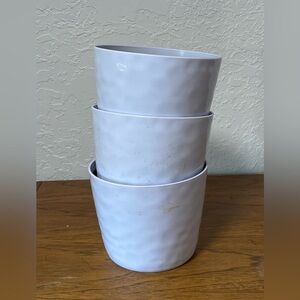 Three small planters with internal drainage.